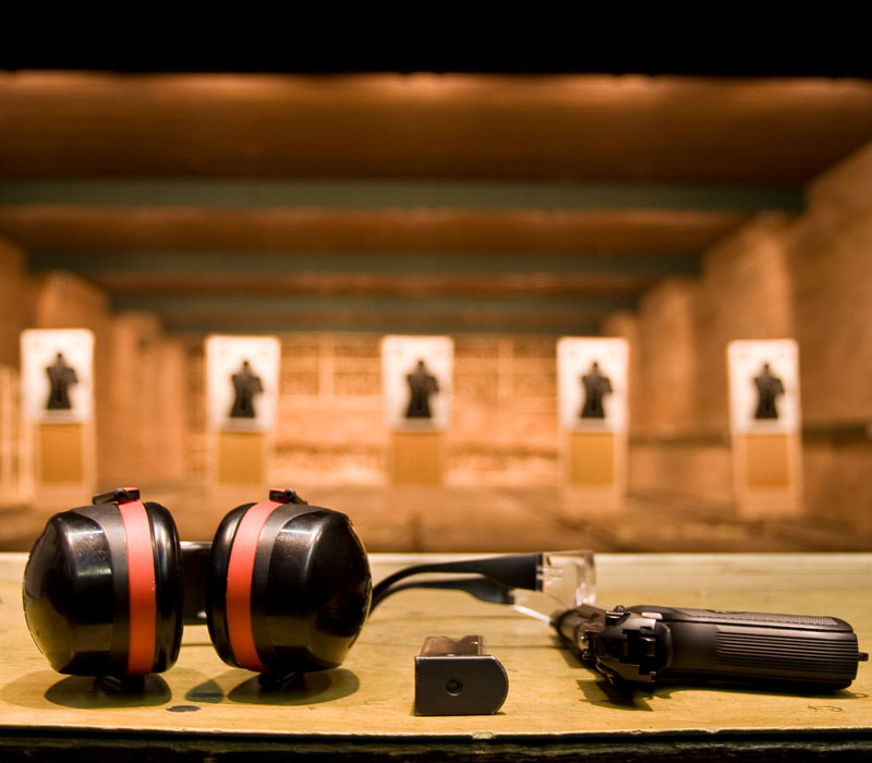 shooting range with gun, safety glasses, and protective headphones